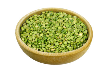 Green lentil beans in wooden bowl, isolated on white, top view