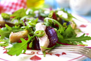 Fresh salad from beetroot,herring,arugula and chard leaves.