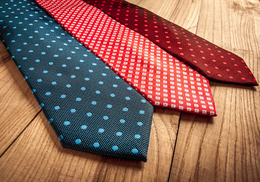 Fathers day composition of three ties hang on wooden wall backround.