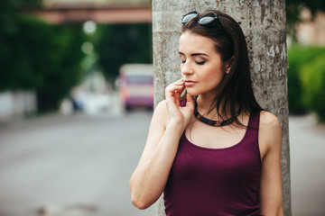 pretty girl sitting in a city street