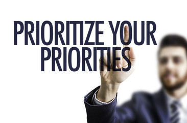 Business man pointing the text: Prioritize Your Priorities