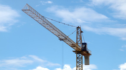 Industrial landscape with cranes on the blue sky