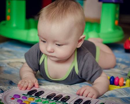 Baby boy playing with piano toy
