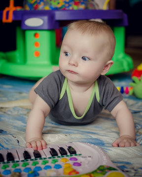 Baby boy playing with piano toy