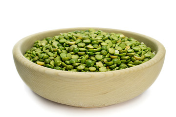 Split peas in wooden bowl isolated on white background