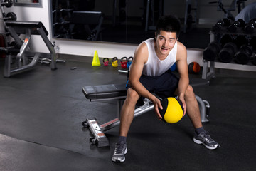 Fototapeta na wymiar handsome young man working out in modern gym