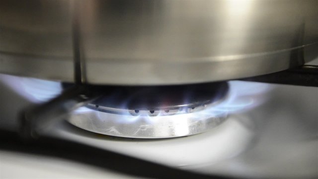 Pan on a gas stove, cooking a meal