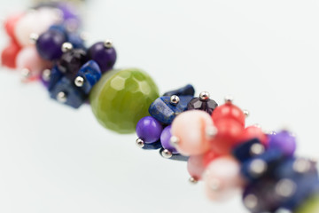 Natural mineral women necklace. Beauty and fashion background with partly defocused different color beads.