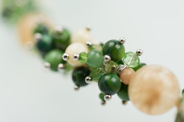 Natural mineral women necklace. Beauty and fashion background with partly defocused different color beads.