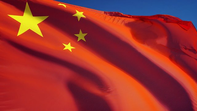 China flag waving in slow motion against clean blue sky, seamlessly looped, close up, isolated on alpha channel with black and white luminance matte, perfect for film, news, digital composition