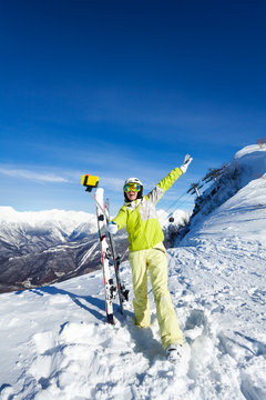 Young girl taking selfie photograph on ski resort