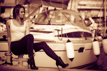 Attractive woman sitting on marina