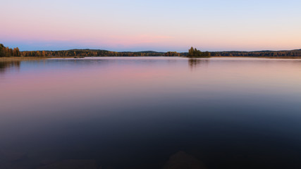 Serene lake scenery at dusk in Finland