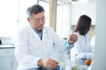 Fototapeta premium people doing chemical experiment in modern lab