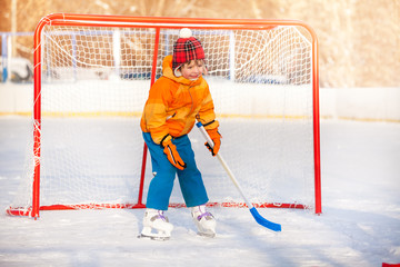 Little boy goalkeeper play ice hockey 
