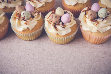Homemade Easter eggs cupcakes, copy space background,toning