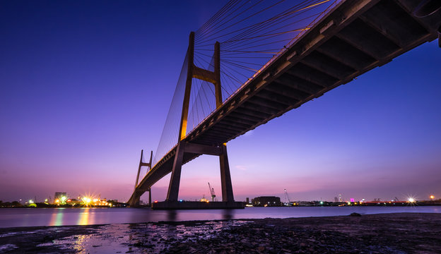Fototapeta Phu My brigde in sunset. This is the important bridge linking district 2 and district 7. Photos were taken in yellow sunset. HO CHI MINH (SAI GON), VIETNAM 10/1/2016.