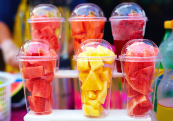 colorful tropical fruits prepared for smoothie on street market