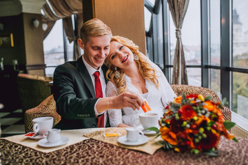 Happy bride and groom in vintage interior of restaurant