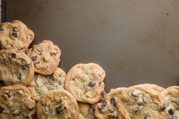 batch of homemade chocolate cookies on baking sheet with copy space
