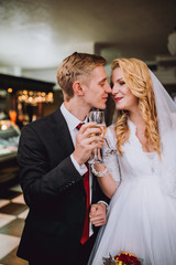 Happy bride and groom in royal vintage interior of restaurant
