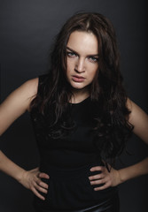 Fototapeta premium High fashion sensual girl in the black dress in the studio