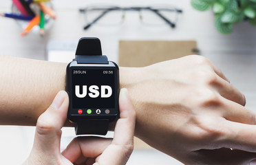 Hand of a businessman holding a clock message USD, Can be used in advertising.