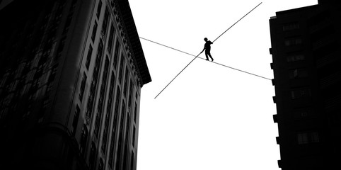 Man balancing on the rope high in the sky