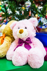 Teddy bear with present on christmas gifts background