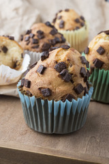 Muffins with chocolate on a wooden table