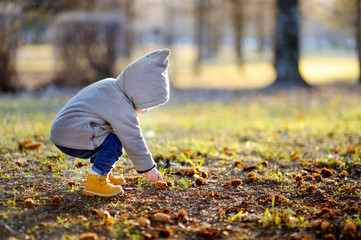 Toddler walking outdoors at the warm spring day