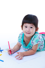 Child lie on the floor and drawing on paper. On white