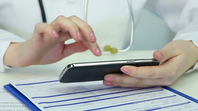 Doctor's hands sliding pages on smartphone screen, prescribing medication online