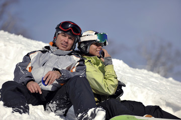 Fototapeta na wymiar snowboarders couple relaxing