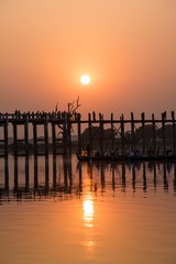 Silhouetted on U Bein Bridge at sunset, Amarapura, Mandalay regi