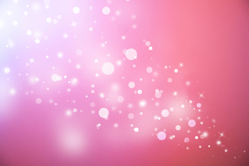 Pink glitter sparkles defocused rays lights bokeh abstract christmas background.