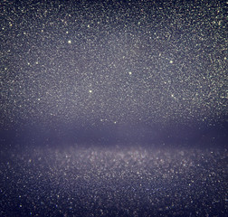 glitter vintage lights background. gold, silver, blue and black. de-focused.
