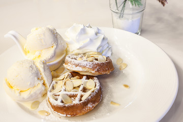 waffle with ice cream, chocolate and vanilla on white plate