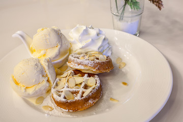 waffle with ice cream, chocolate and vanilla on white plate