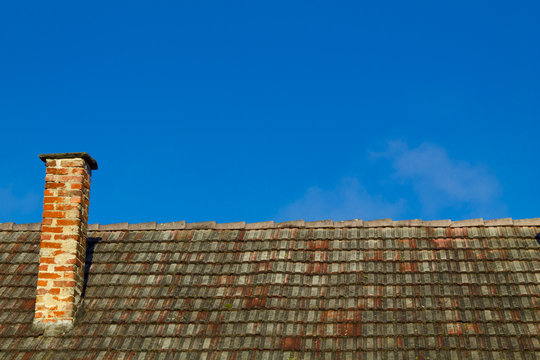 Roof chimney on a blue sky