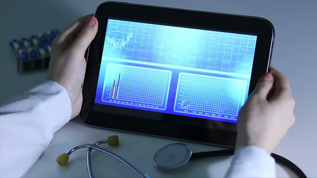 Epidemiologist investigating patterns of disease, comparing statistics on tablet