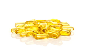 Fish Oil Supplements. A pile of fish oil supplement capsules isolated on a white background.