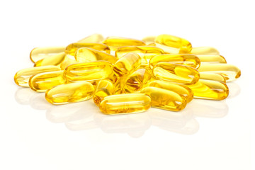 Fish Oil Supplements. A pile of fish oil supplement capsules isolated on a white background.