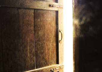 Old dark room with shining closed door.