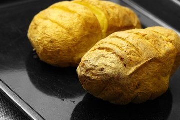 Baked potato / Baked potatoes cooked on a baking tray.