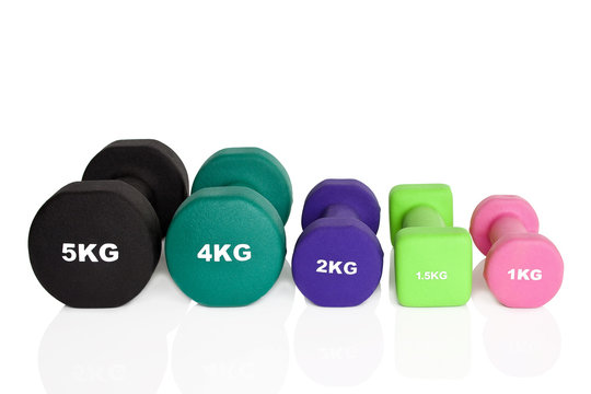 Fitness dumbbells. Black, green, pink and purple dumbbells isolated on white background. Weights for a fitness training.