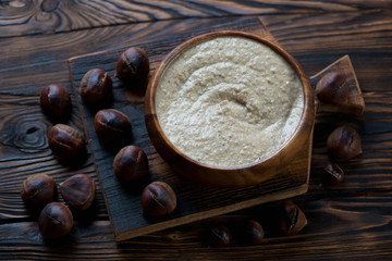 Still life with chestnut soup in a rustic wooden setting