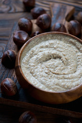 Close-up of a wooden bowl with chestnut cream-soup