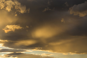 Naklejka na ściany i meble golden sunset sky and glowing cloud, twilight sky before rain