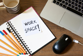 Notebook and laptop on old wooden desk